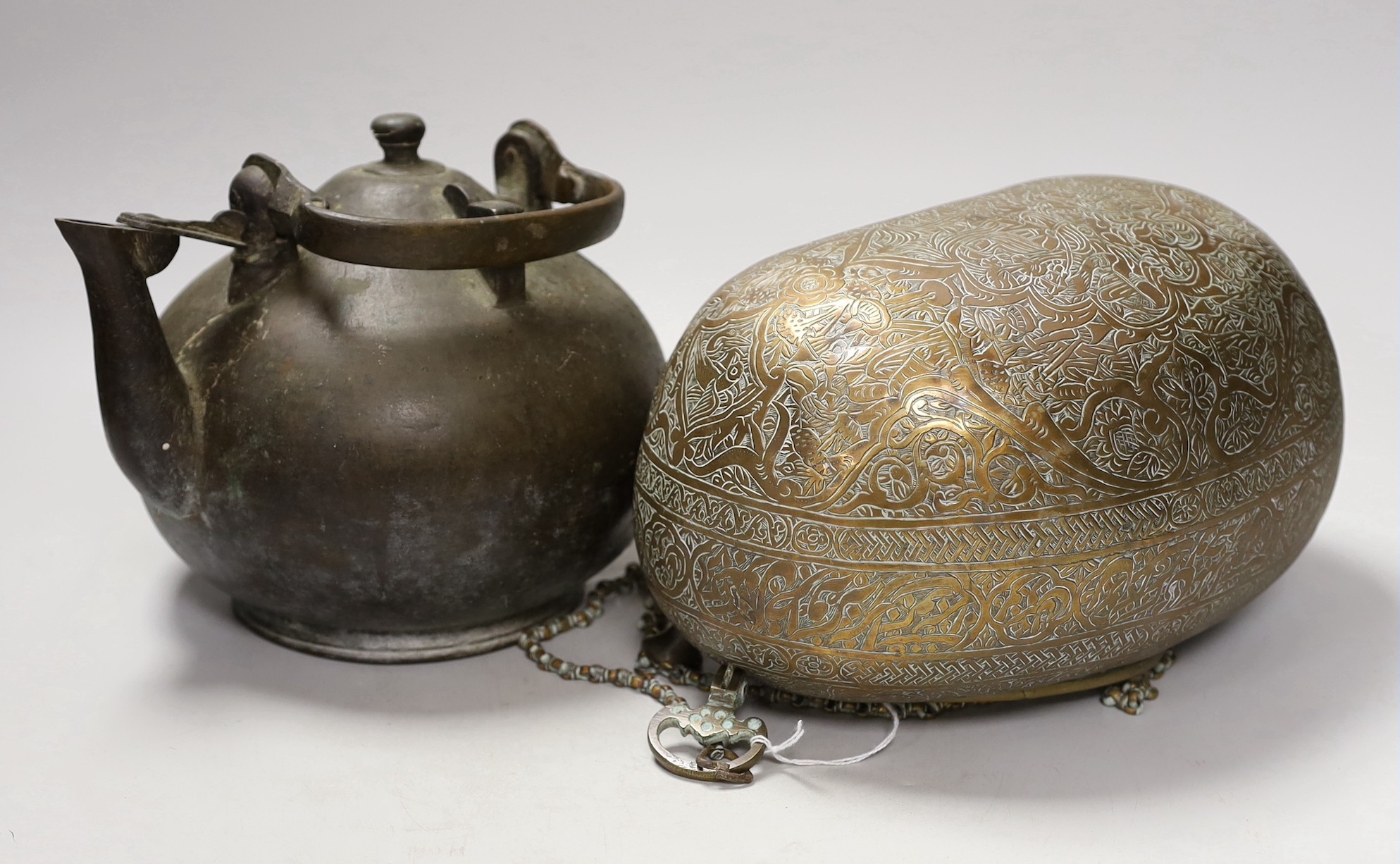 A 19th century Persian engraved brass kashkul, Qajar dynasty, 16cm wide and a bronze kettle, 17cm tall